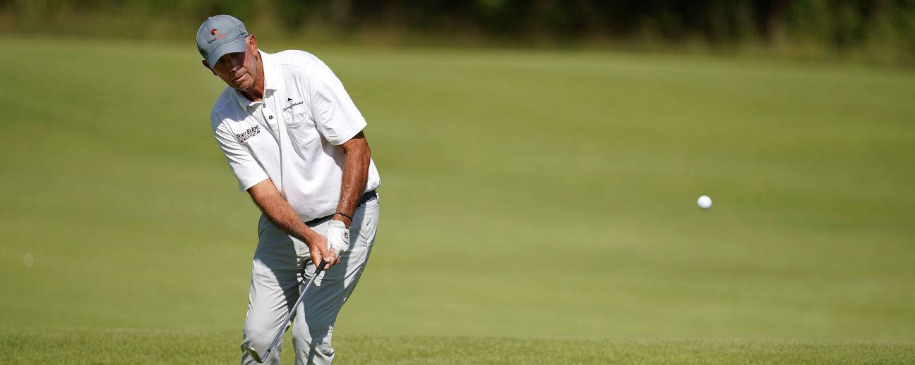 Tom Lehman Hitting A Golf Ball Background