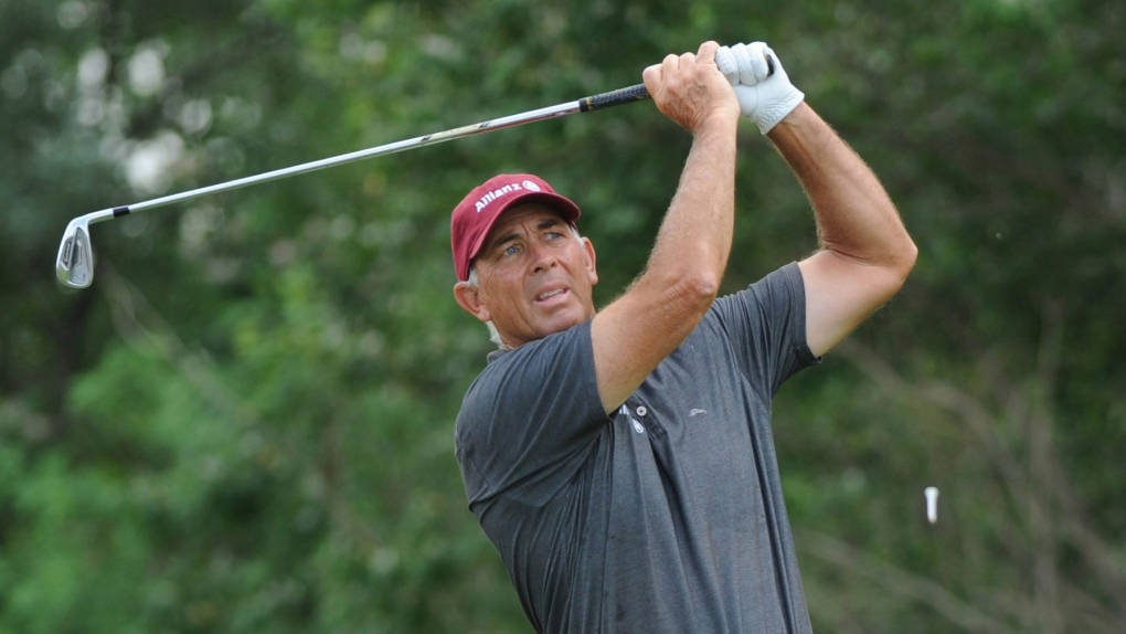 Tom Lehman Swinging A Golf Club Background