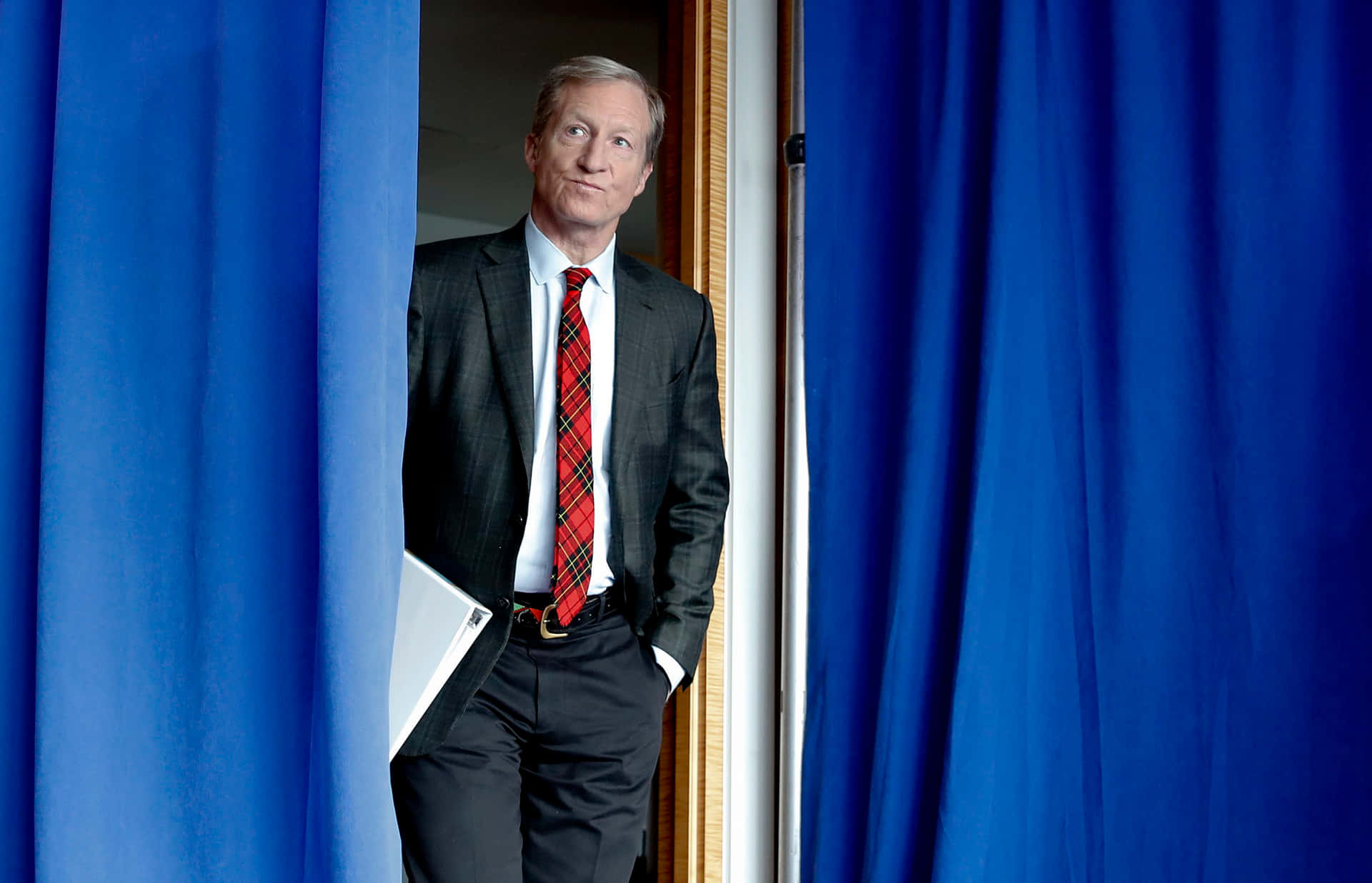 Tom Steyer In Blue Curtain Background