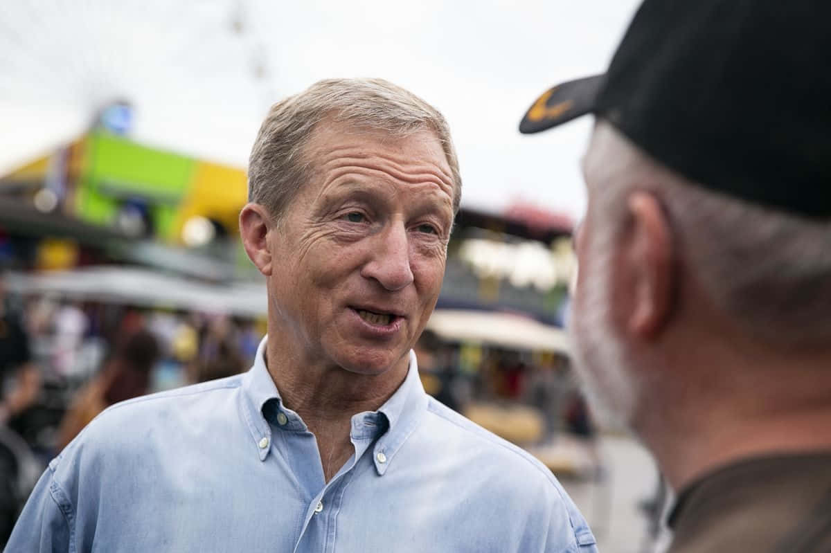 Tom Steyer With A Man In Cap Background