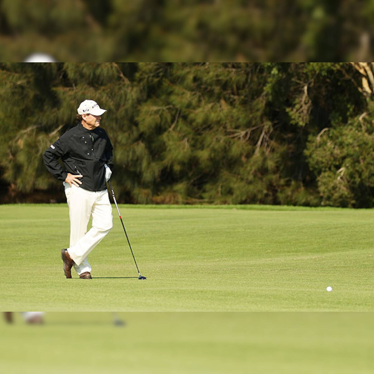 Tom Watson Deep In Thought On The Golf Course Background