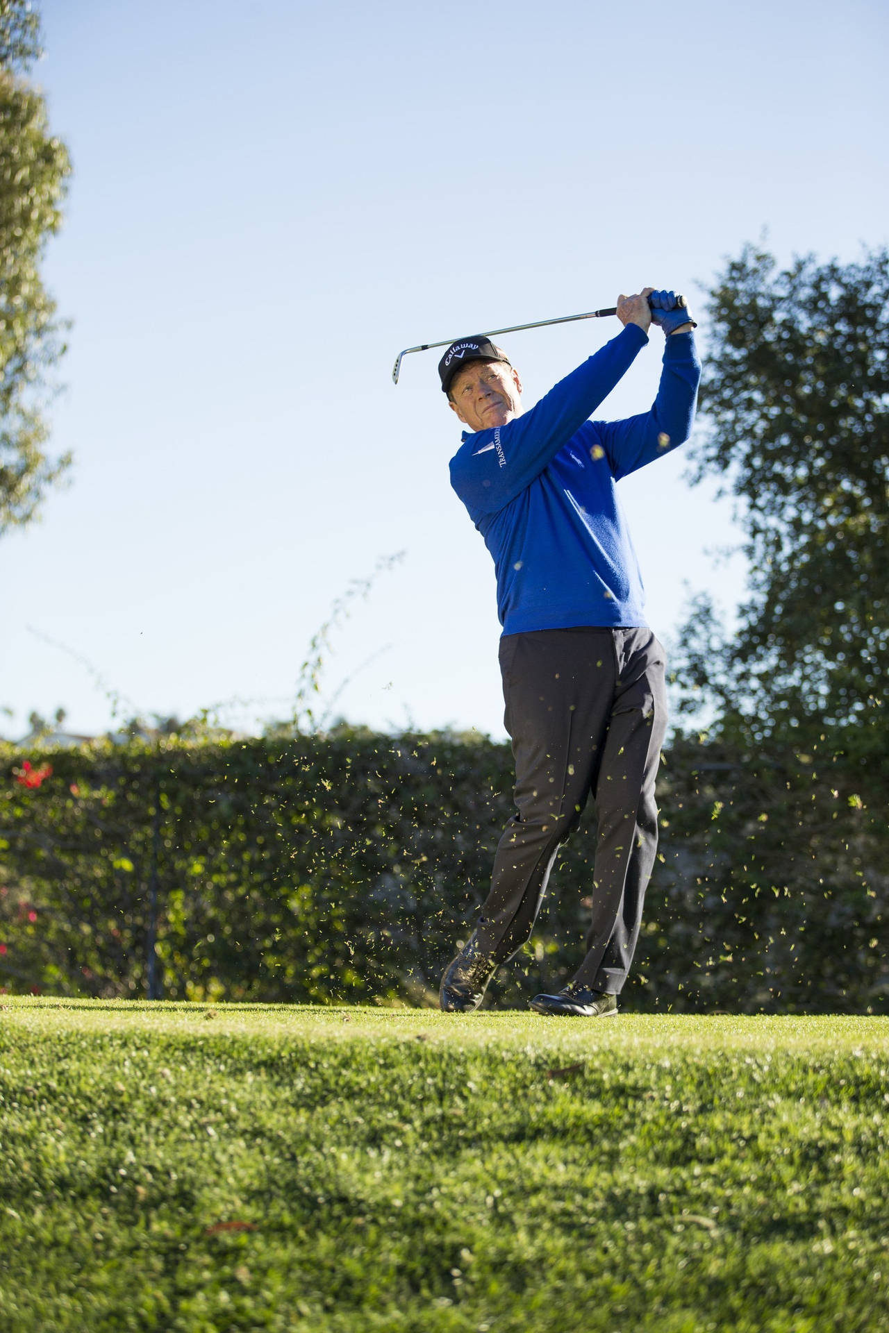 Tom Watson Hitting A Golf Ball Background