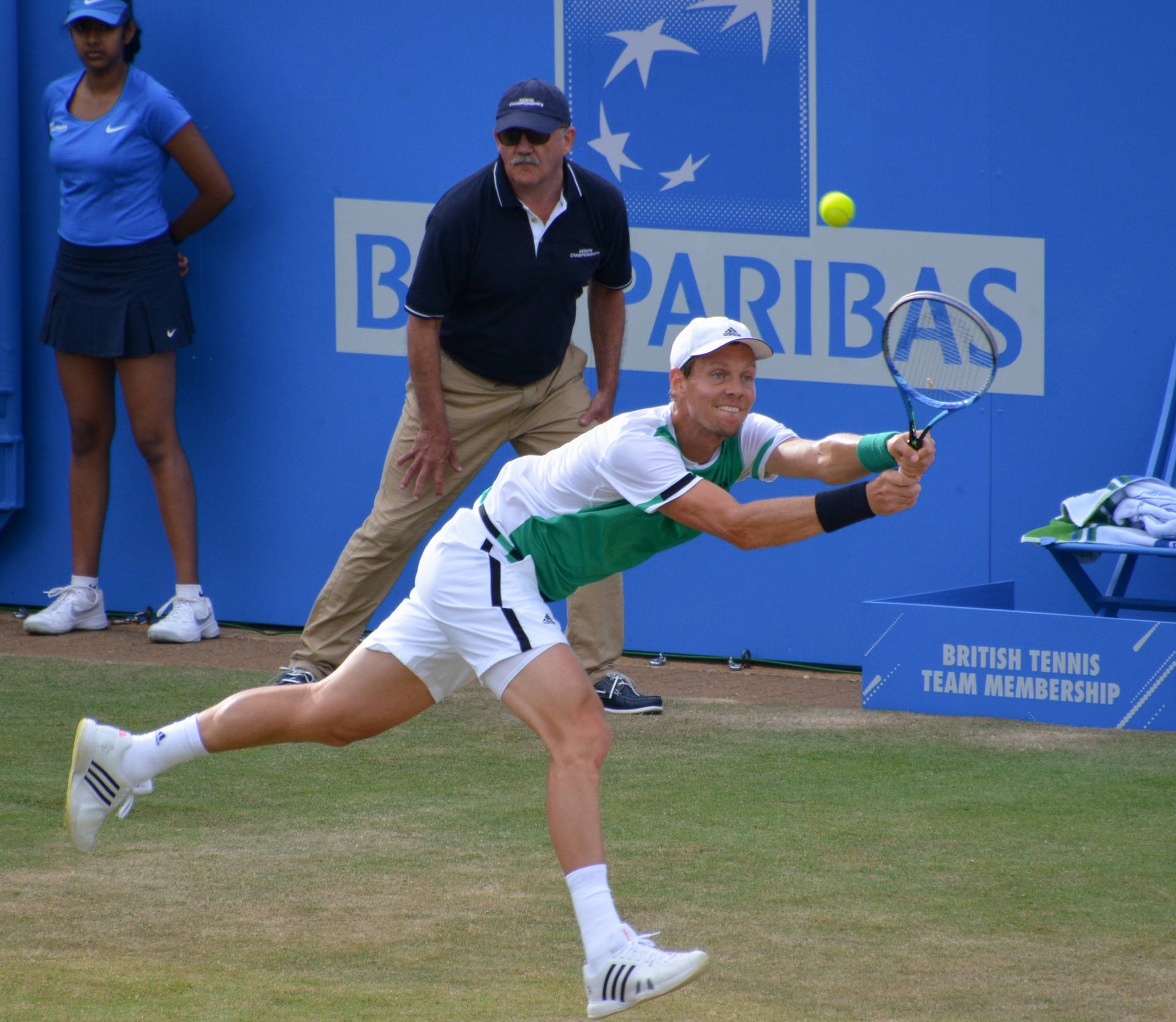 Tomas Berdych Trying To Hit Yellow Ball Background