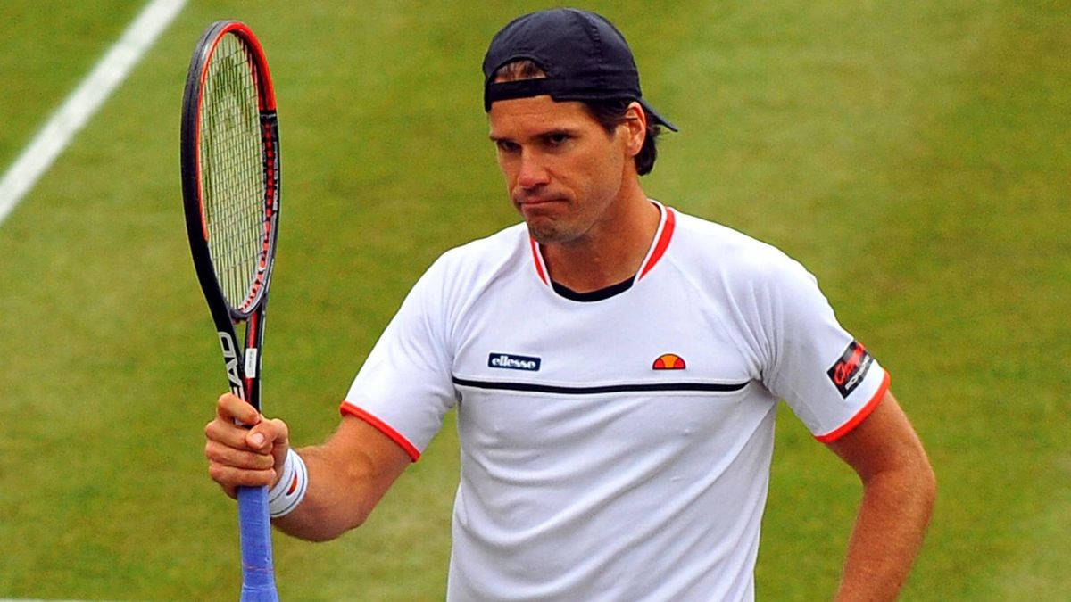 Tommy Haas Holding Up Racket Background