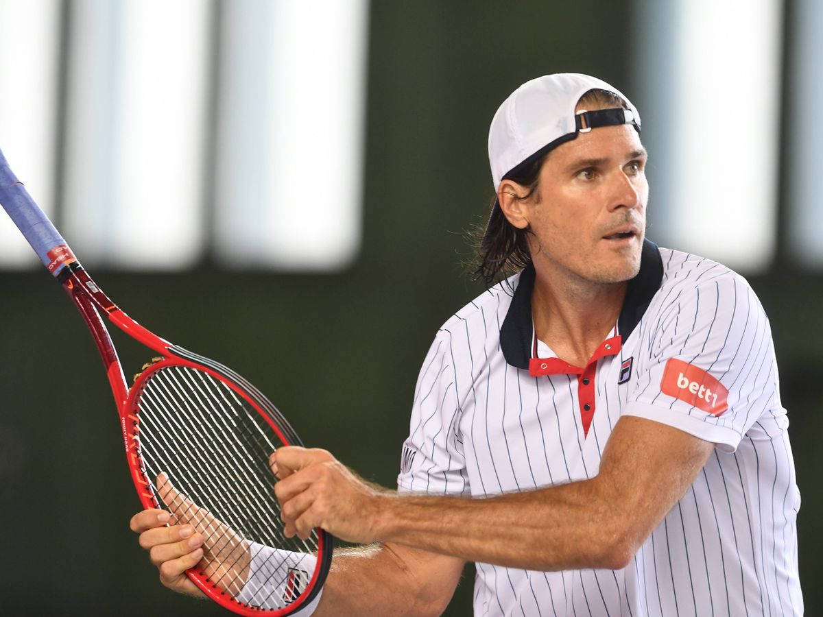 Tommy Haas With Upside Down Racket Background