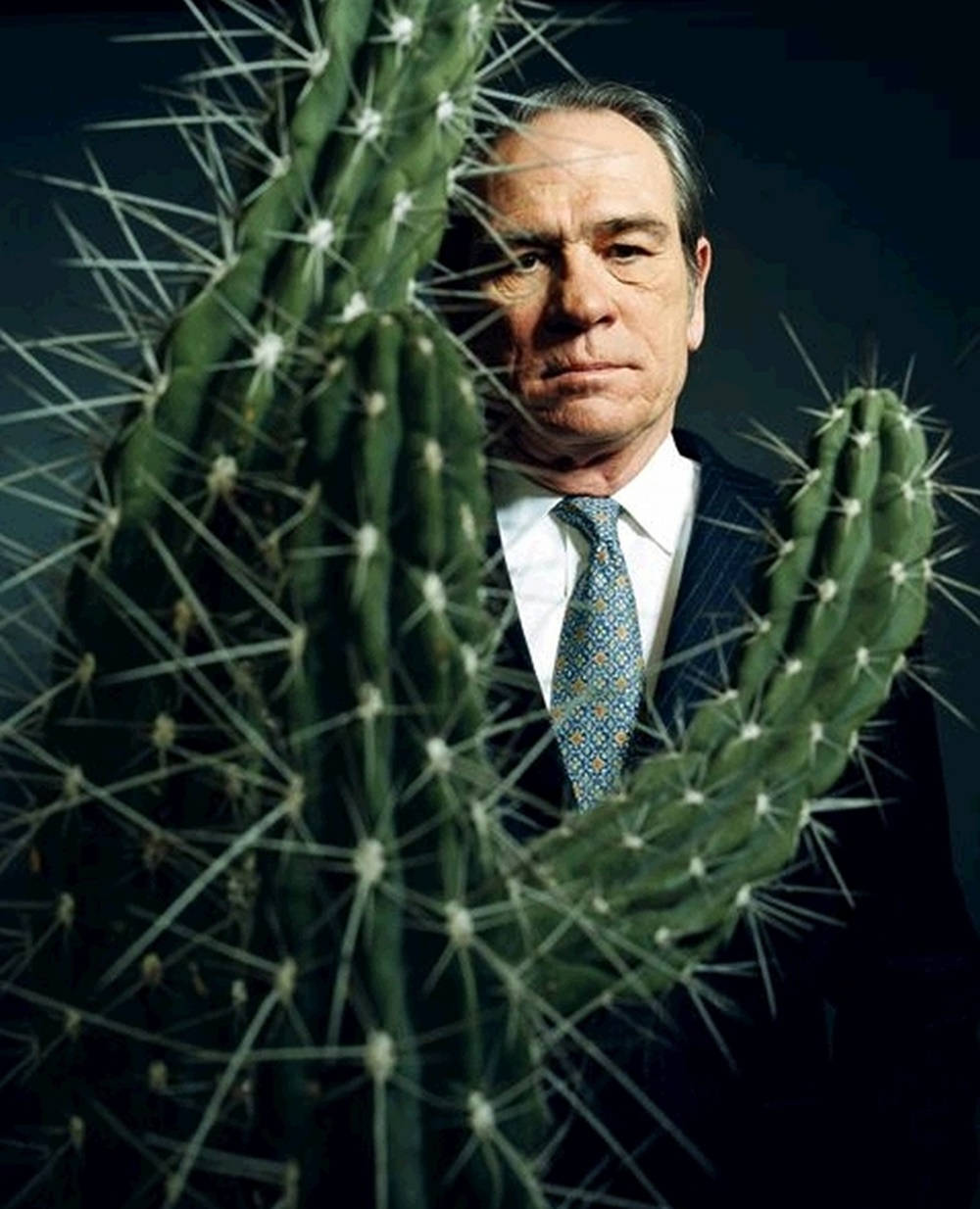 Tommy Lee Jones Behind A Cactus Plant Background