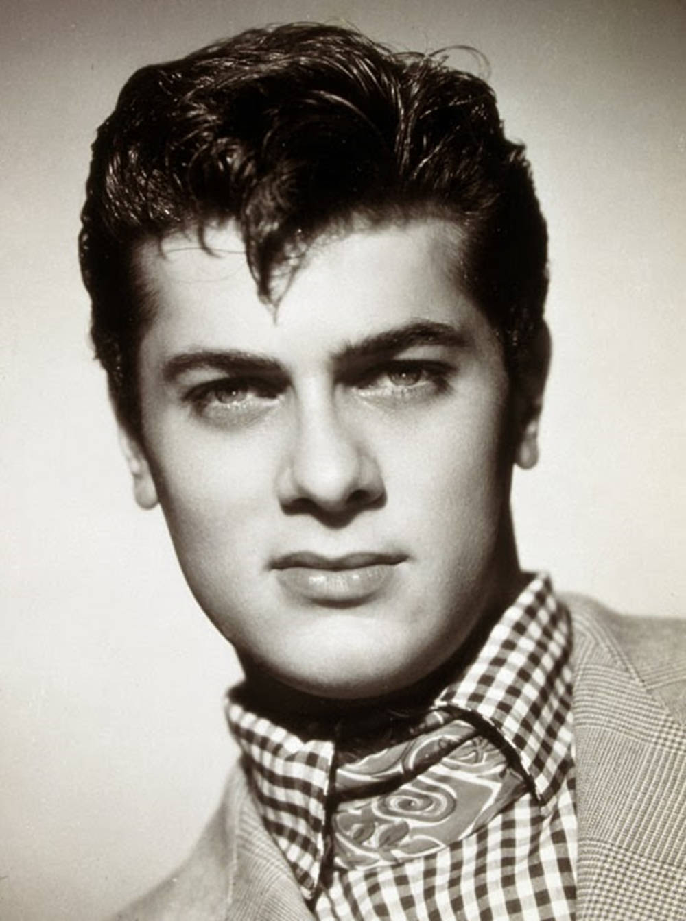 Tony Curtis In Classic Checkered Attire Background