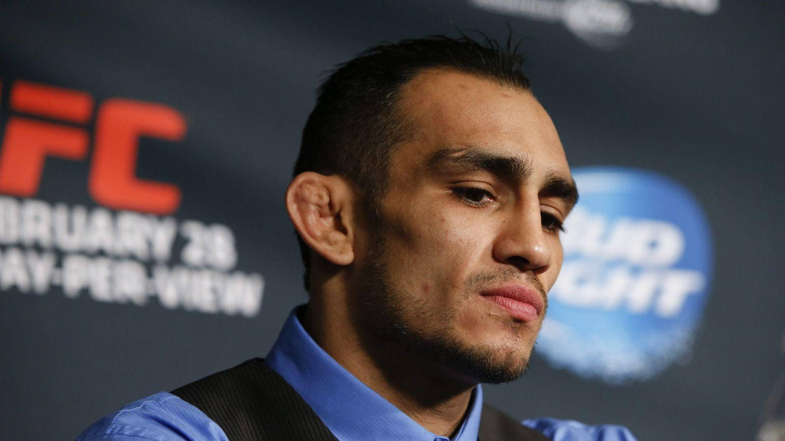 Tony Ferguson Confidently Speaking At A Press Conference Background