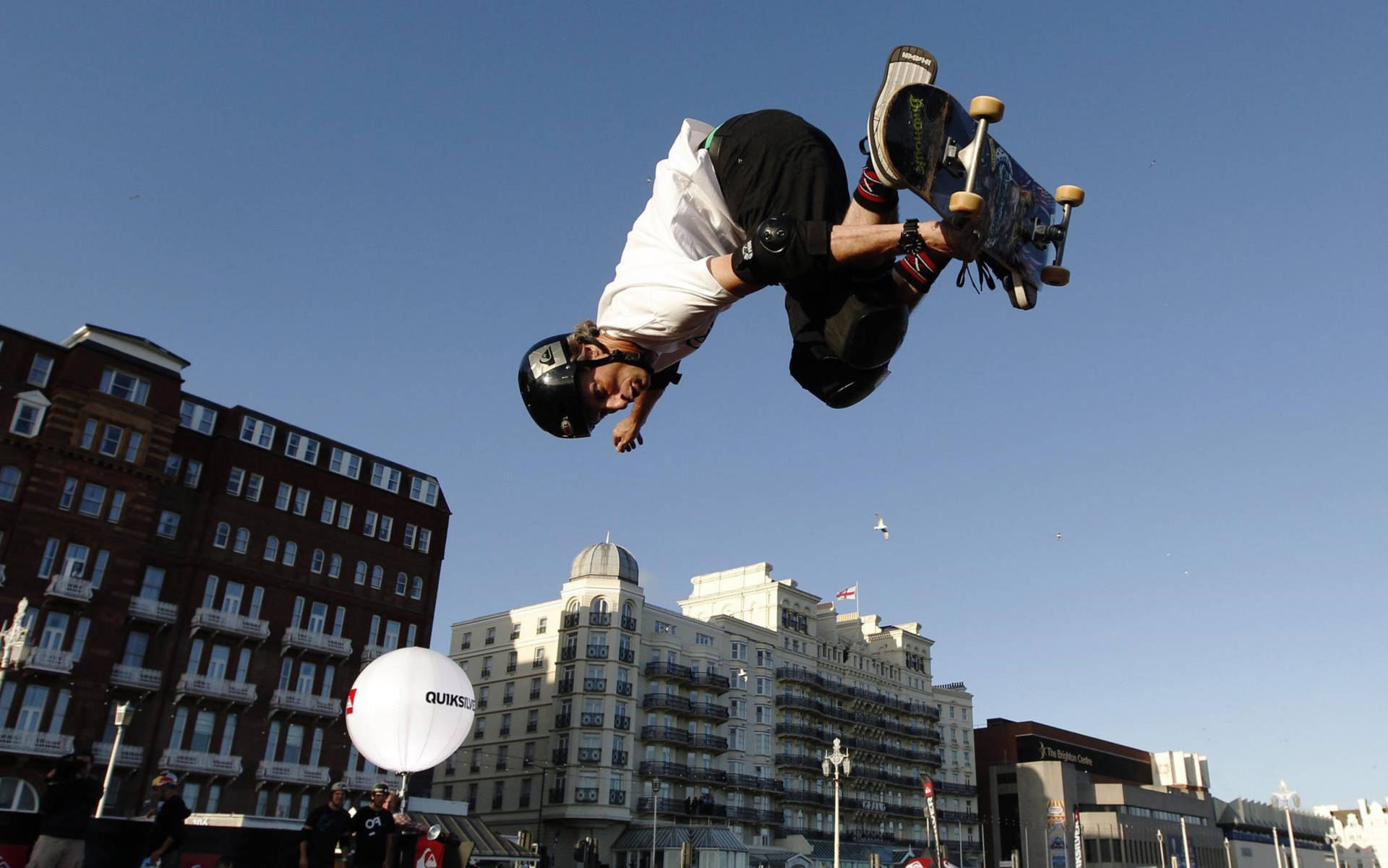 Tony Hawk Skateboard Over City Background