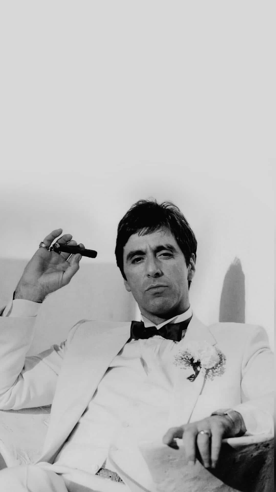 Tony Montana Relaxing With Cigar Background