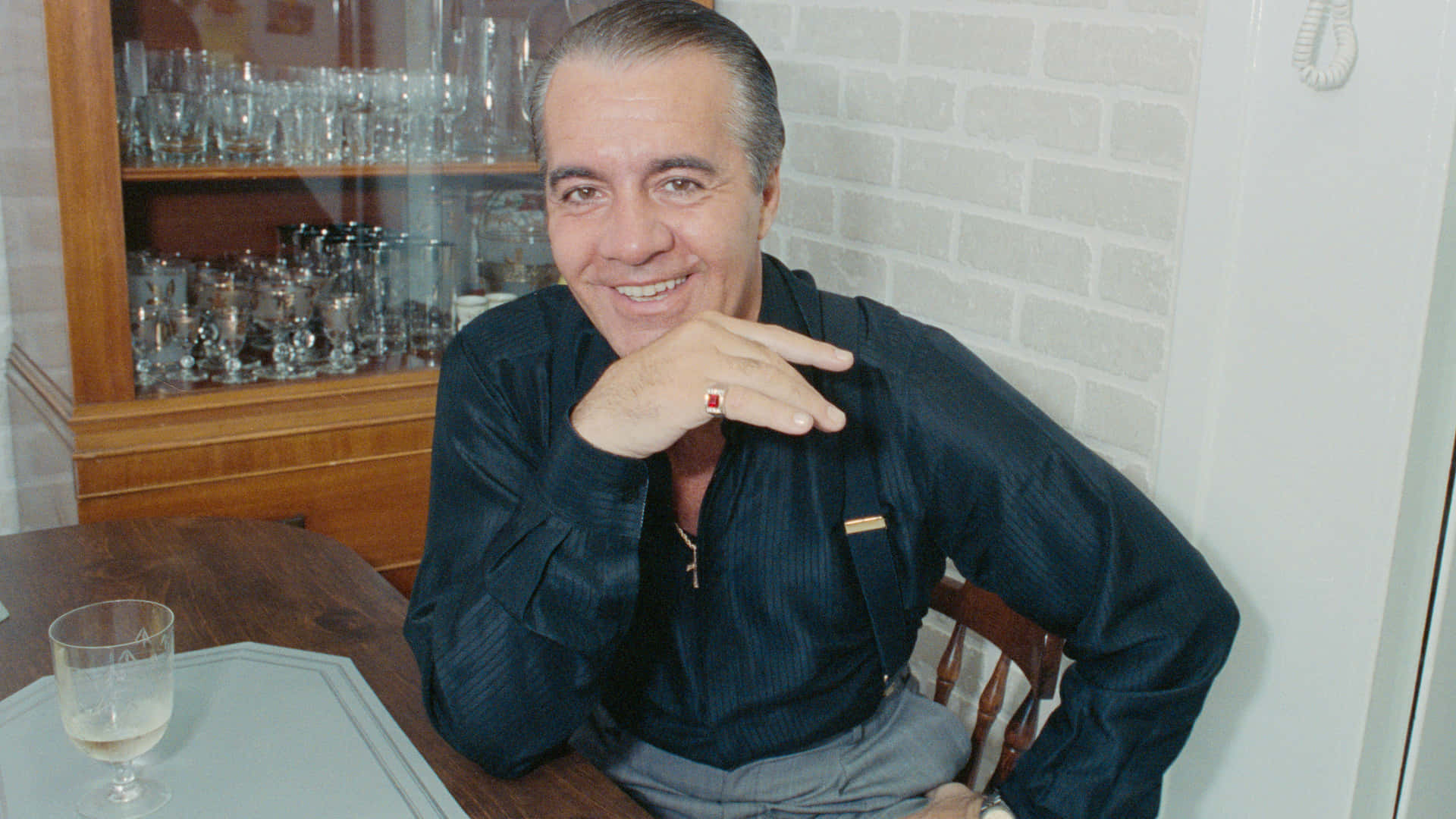 Tony Sirico Posing For The Camera With A Confident Smile Background