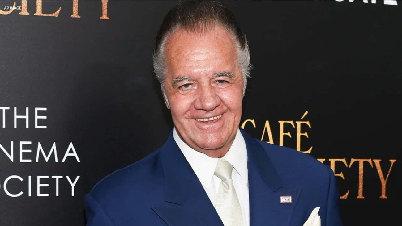 Tony Sirico Strikes A Pose In A Fashionable Suit. Background
