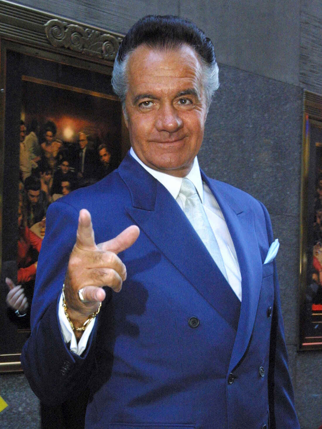 Tony Sirico Striking A Pose In A Black Suit Background