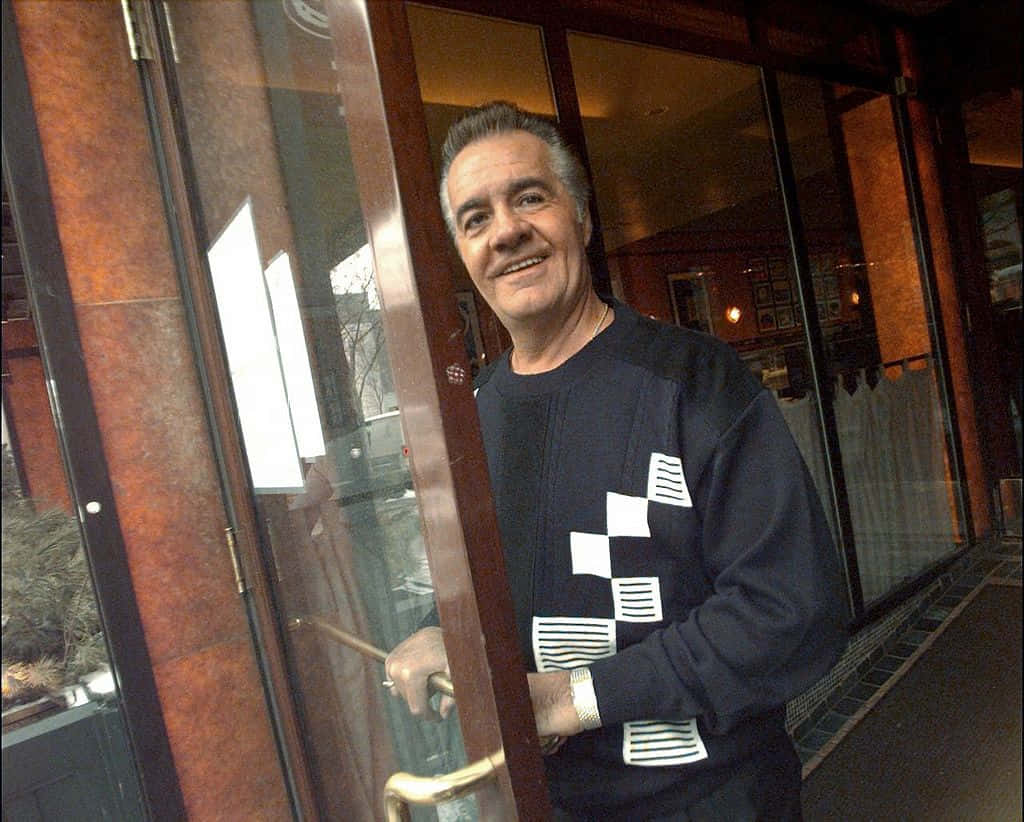 Tony Sirico Striking A Pose In A Classic Black Suit Background