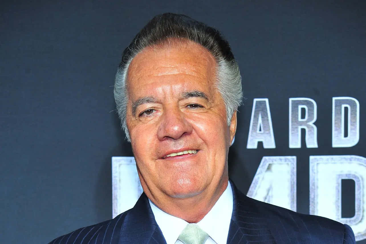 Tony Sirico Striking A Pose In A Photoshoot Background
