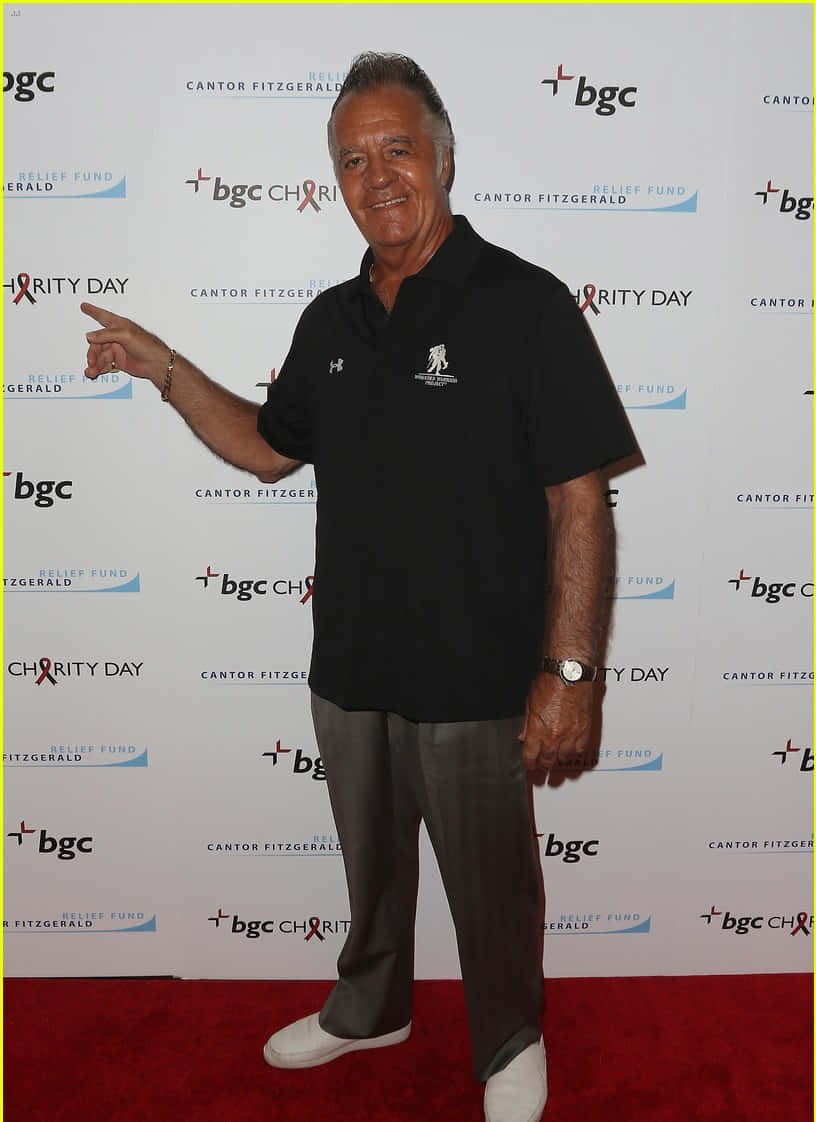 Tony Sirico Striking A Pose In A Suit Background