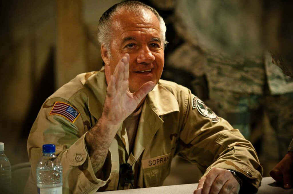 Tony Sirico Striking A Pose In A Suit And Sunglasses Background