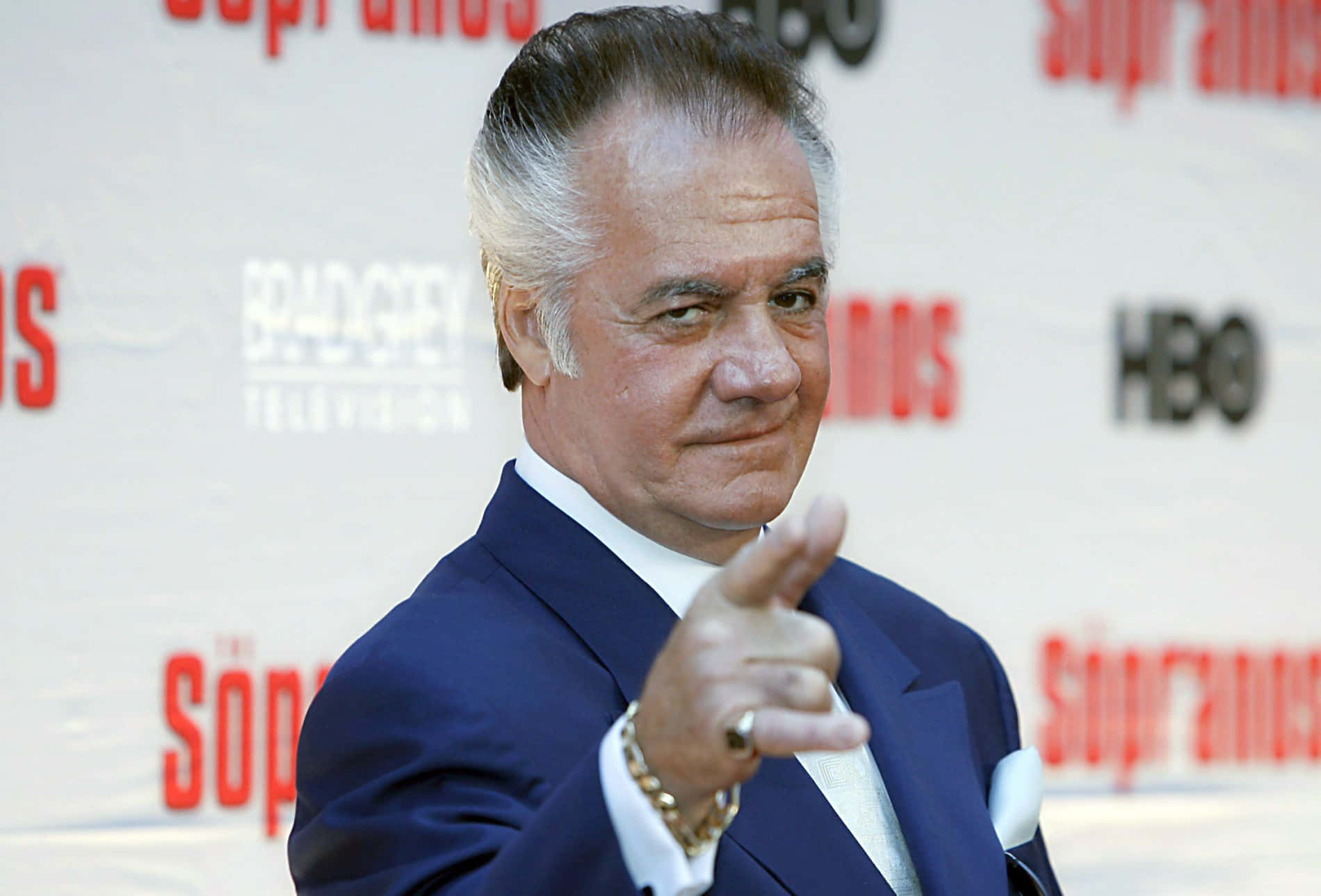 Tony Sirico Striking A Pose In A Suit Background