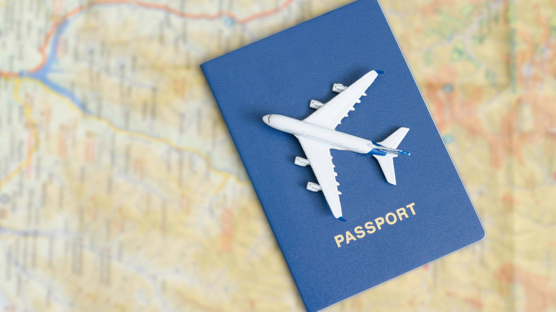 Top View Passport And Toy Airplanetravel Map Background