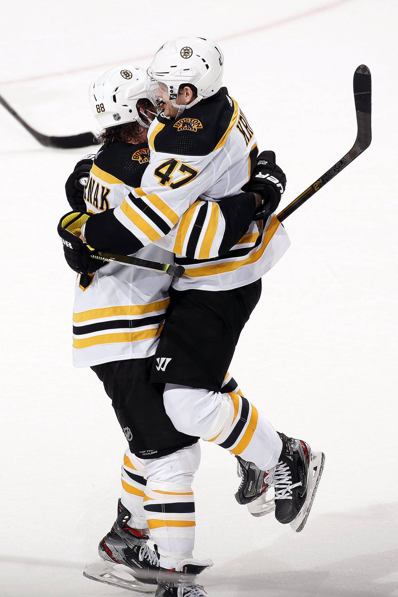 Torey Krug Hugging David Pastrnak Background