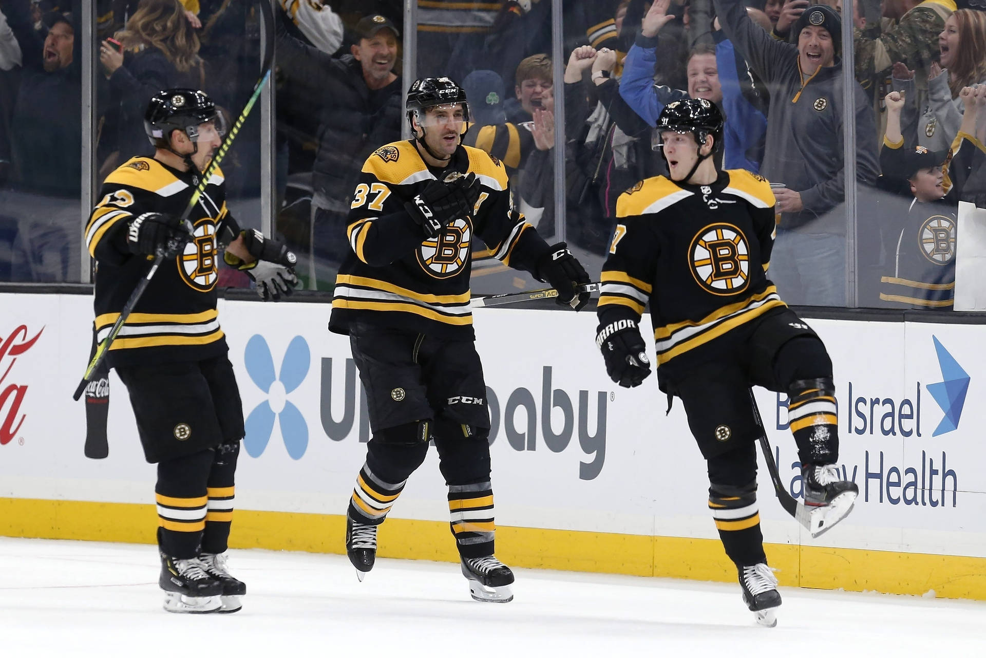 Torey Krug With Brad Marchand And Patrice Bergeron Background