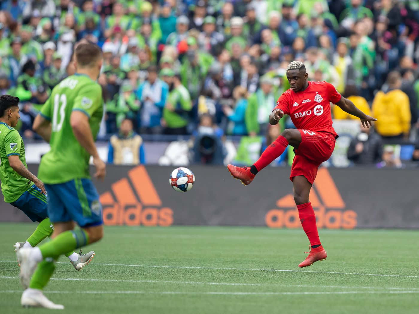 Toronto Fc Chris Mavinga Kicking Football Background