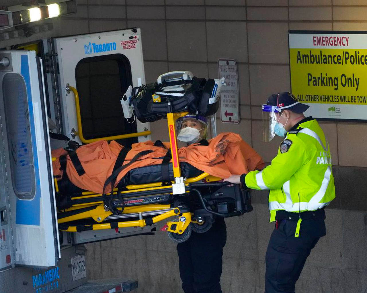 Toronto Paramedic Aiding Patient Transfer