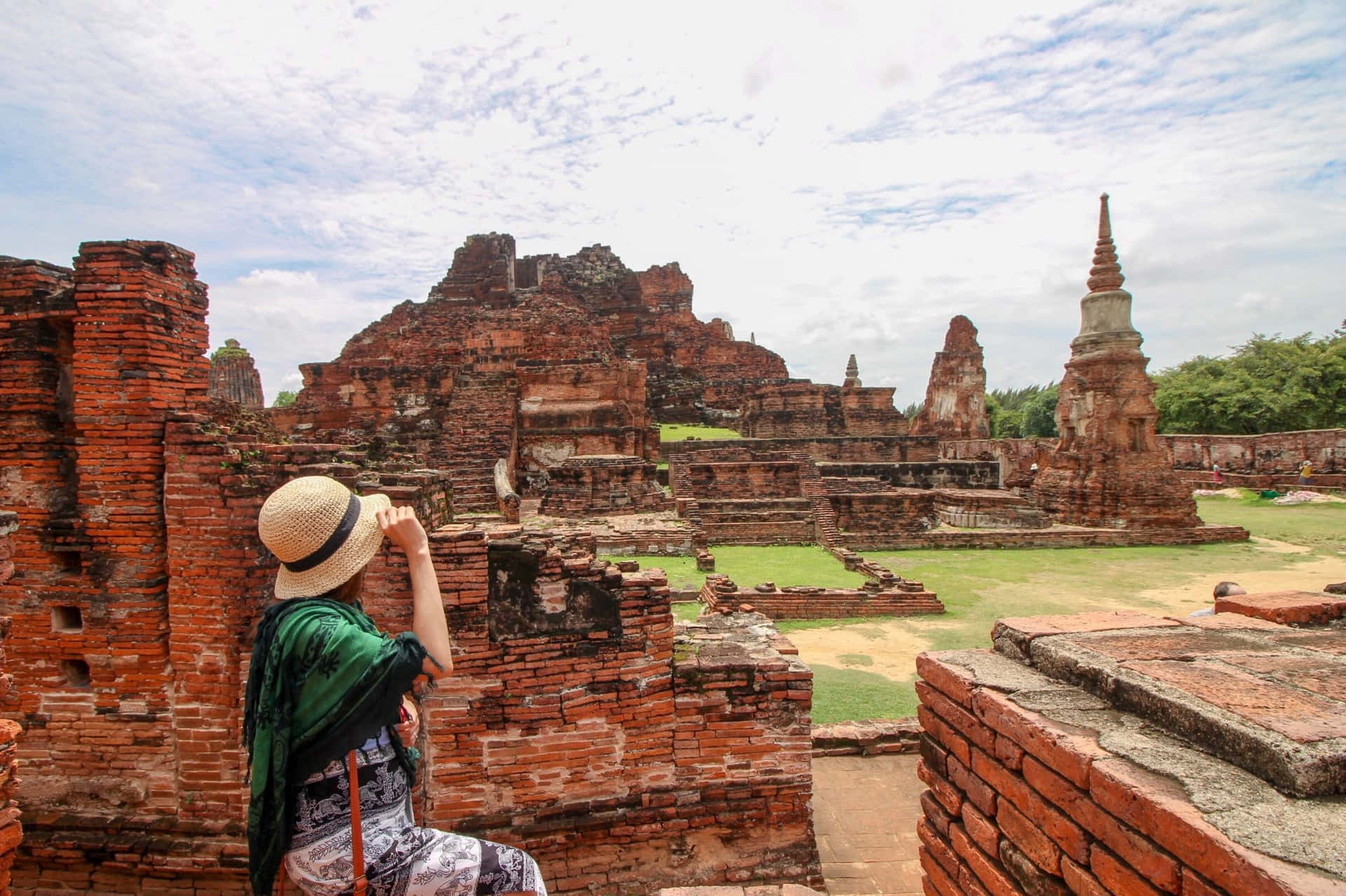Tourist Exploring Ayutthaya Ruins Background