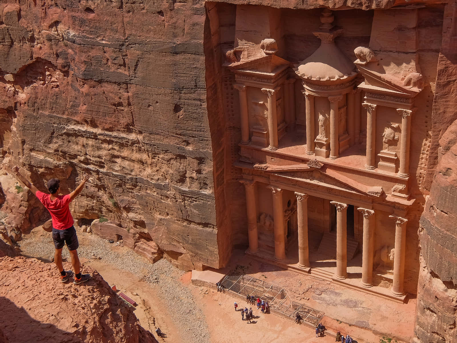 Tourist On A Cliff In Petra Background