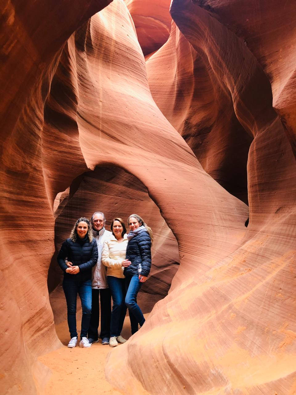 Tourists Exploring The Enchanting Antelope Canyon Background