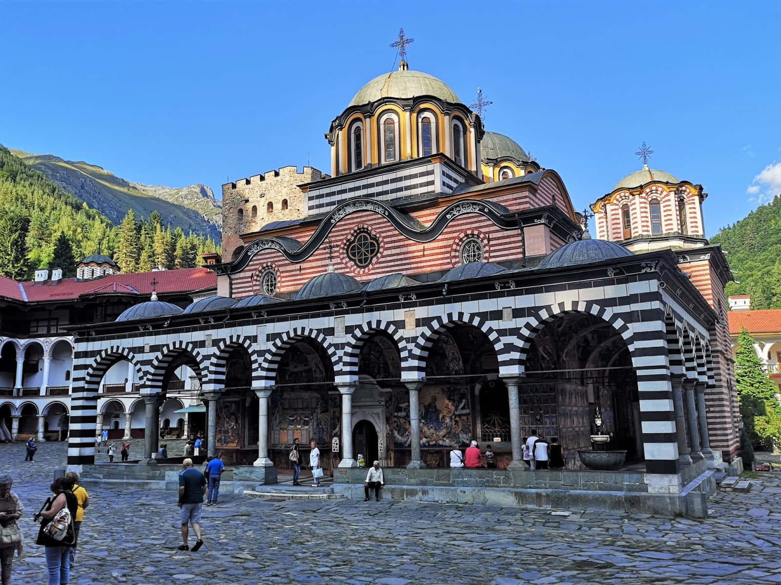 Tourists Exploring The Picturesque Rila Monastery
