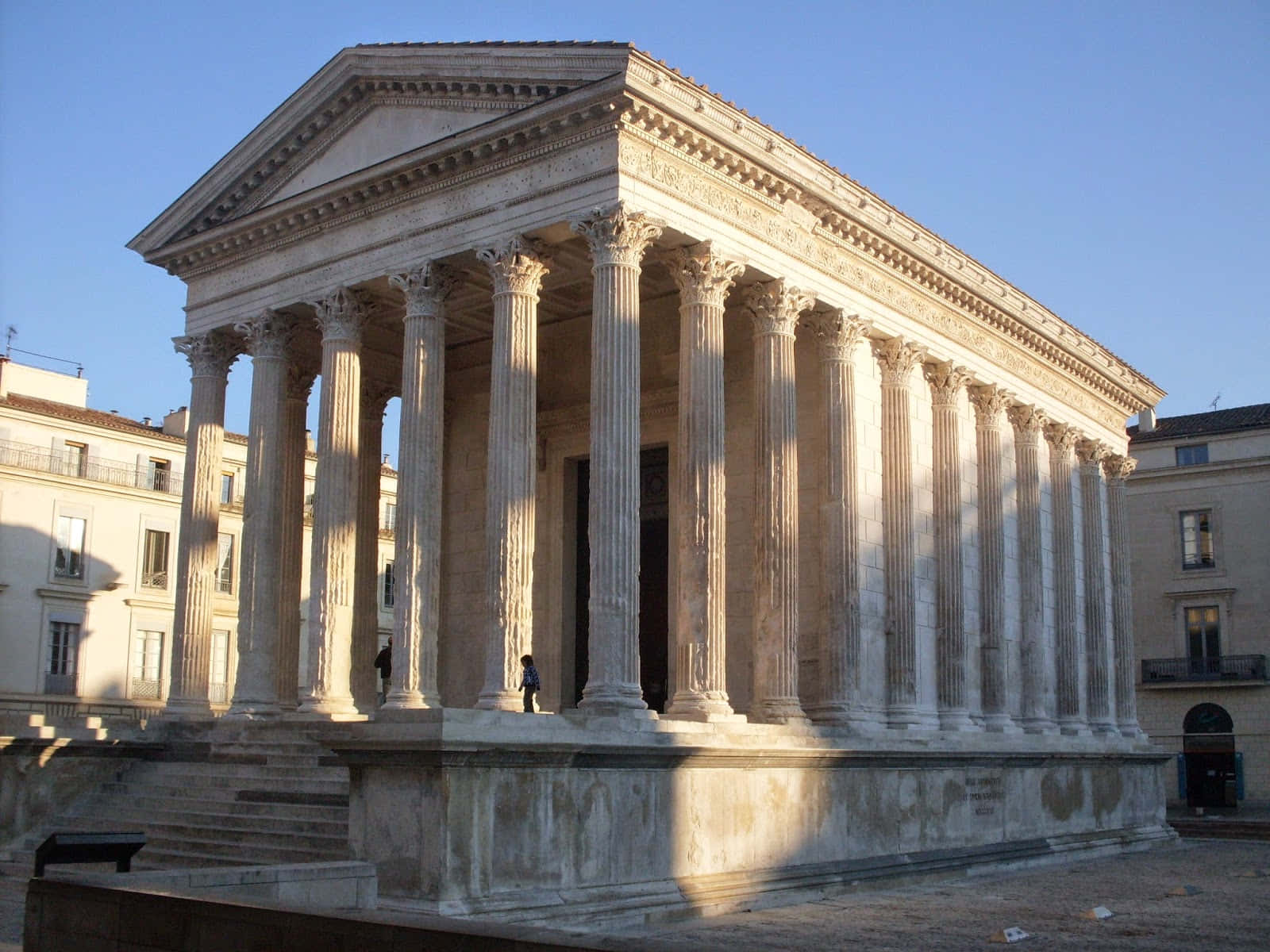 Tourists Visiting The Historical Maison Carrée Background