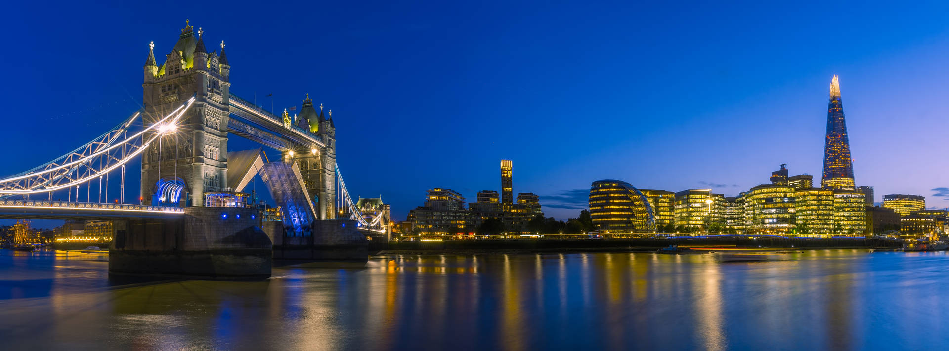 Tower Bridge And Buildings At Night Background