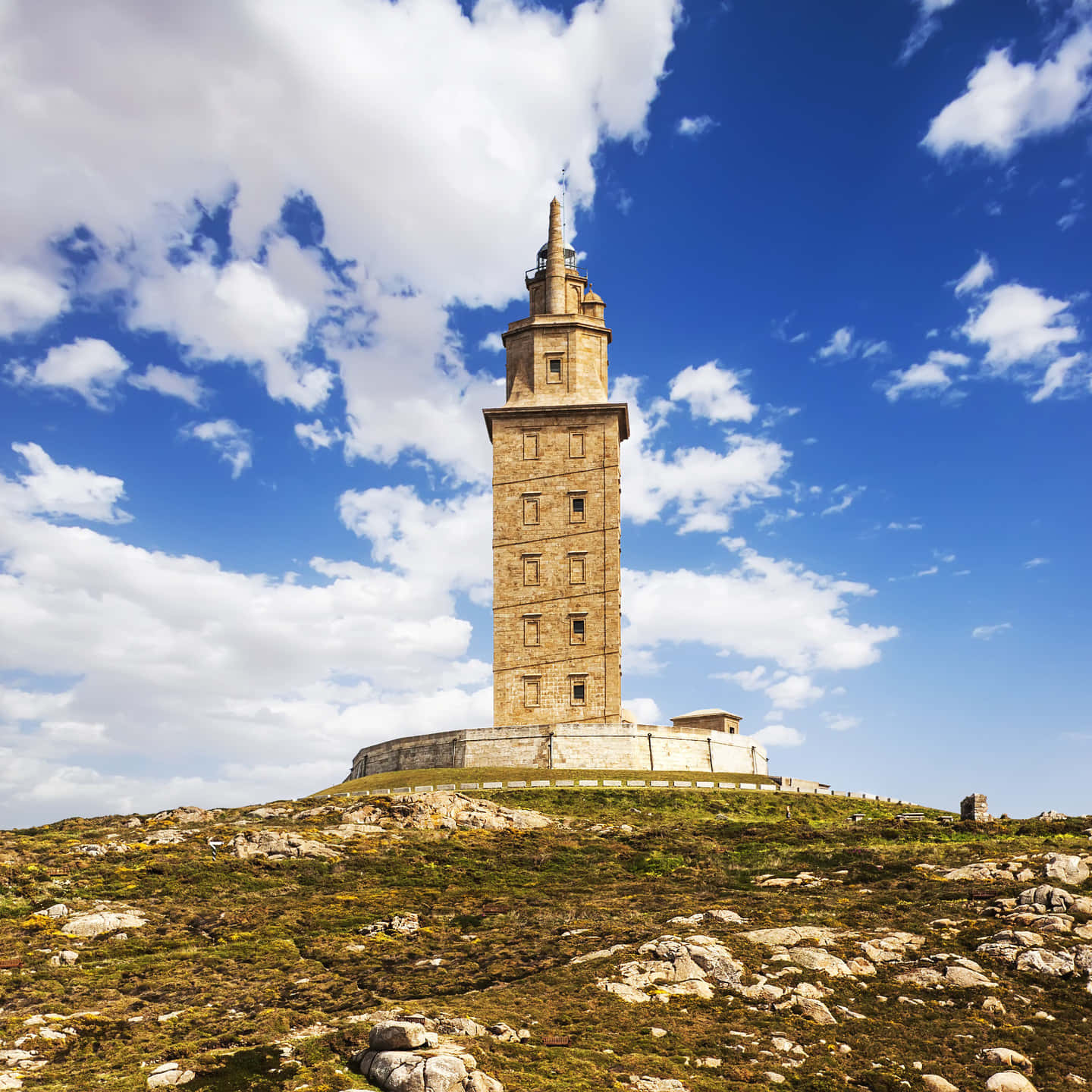 Tower Of Hercules Beneath Cloudy Blue Sky Background