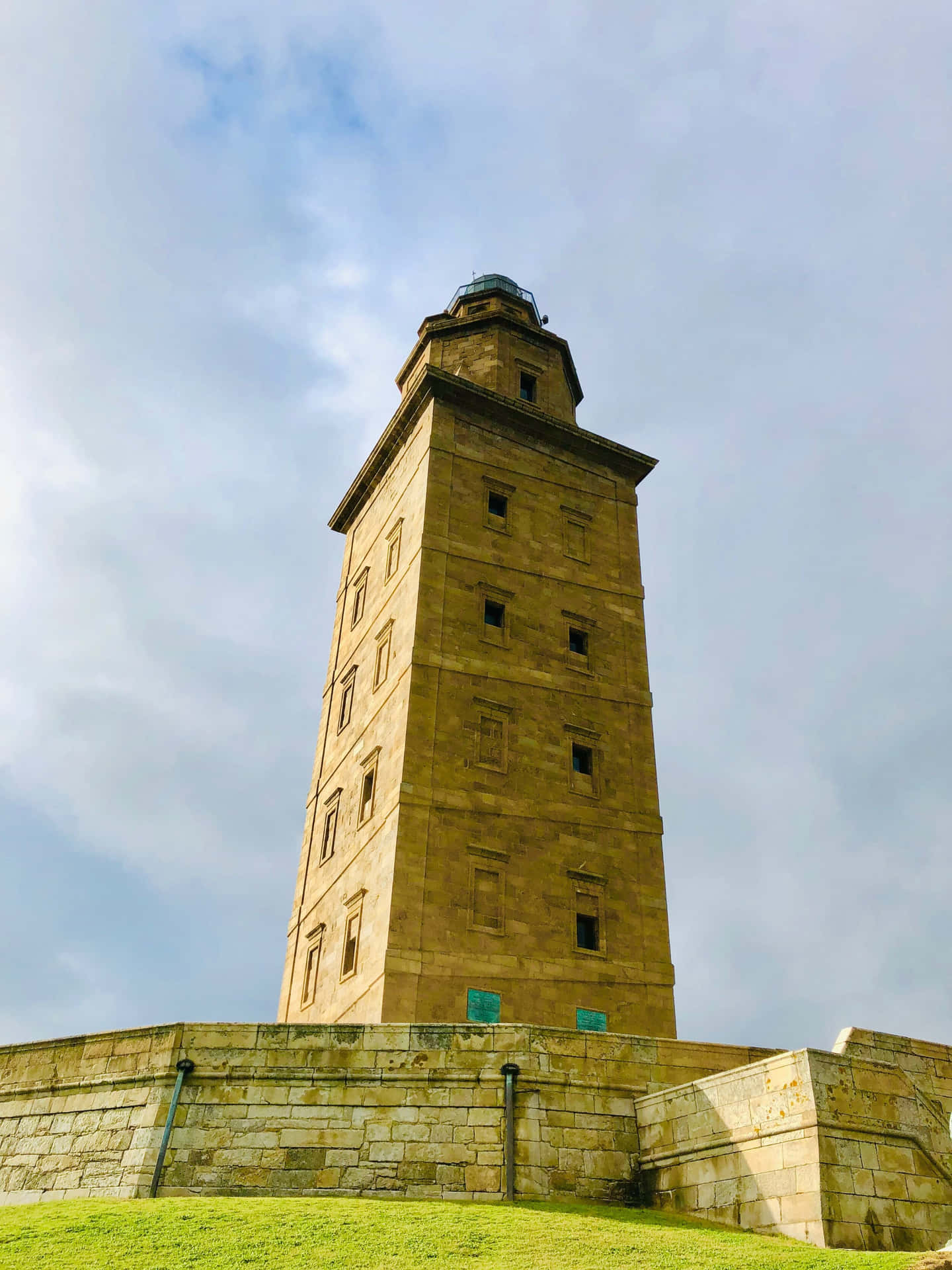 Tower Of Hercules Beneath The Cloudy Sky Background