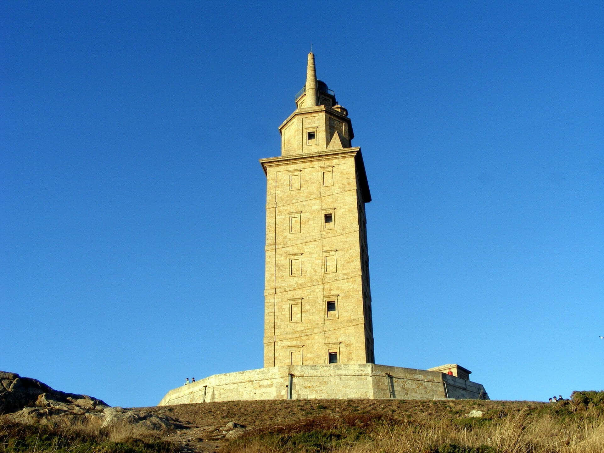 Tower Of Hercules Contrasting With The Blue Sky Background