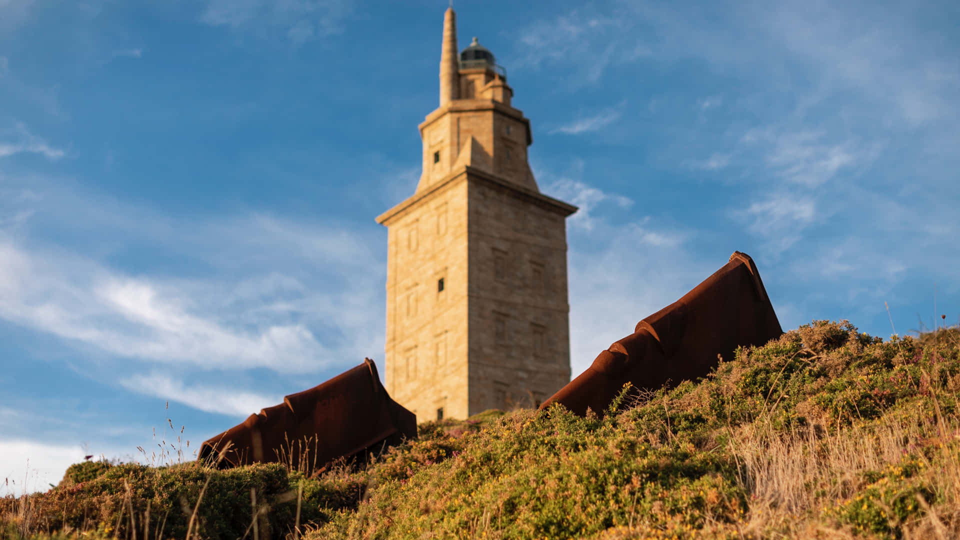 Tower Of Hercules In The Orange Grass Background