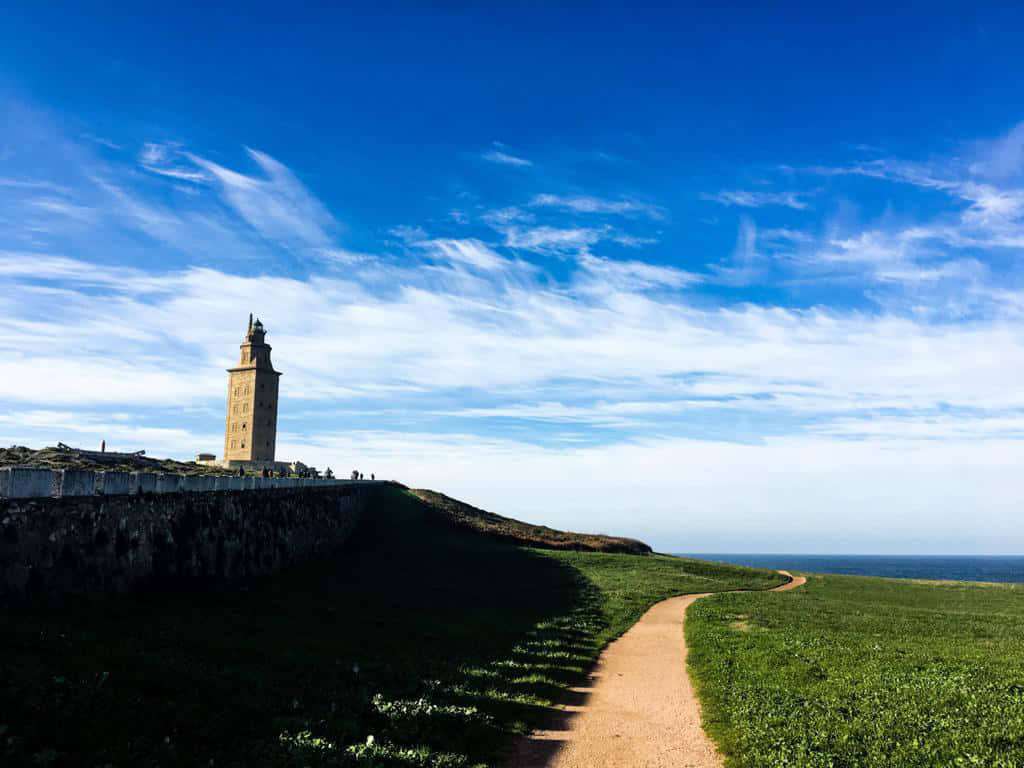 Tower Of Hercules Jutting From Grass Background