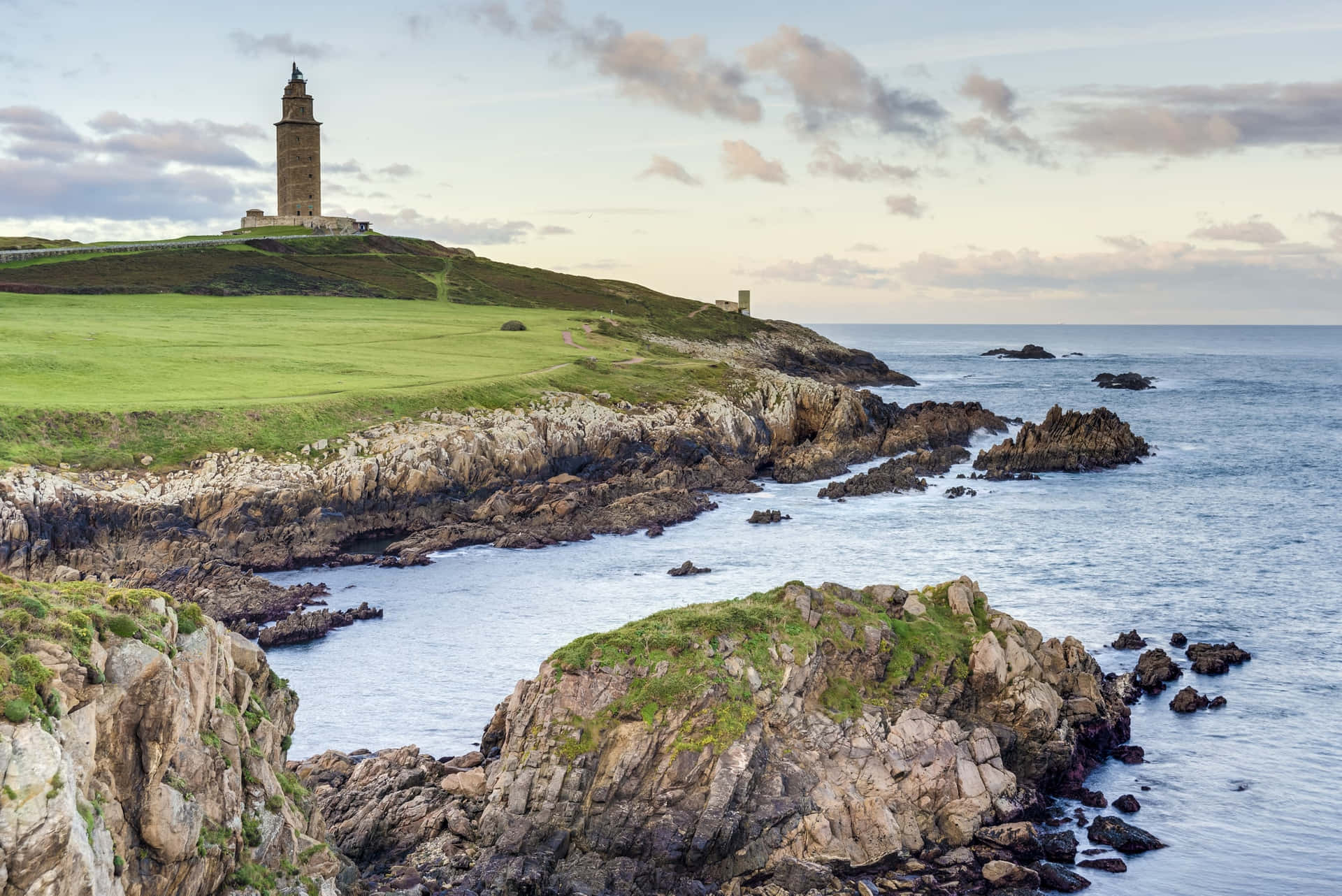 Tower Of Hercules Standing Atop The Coast Background
