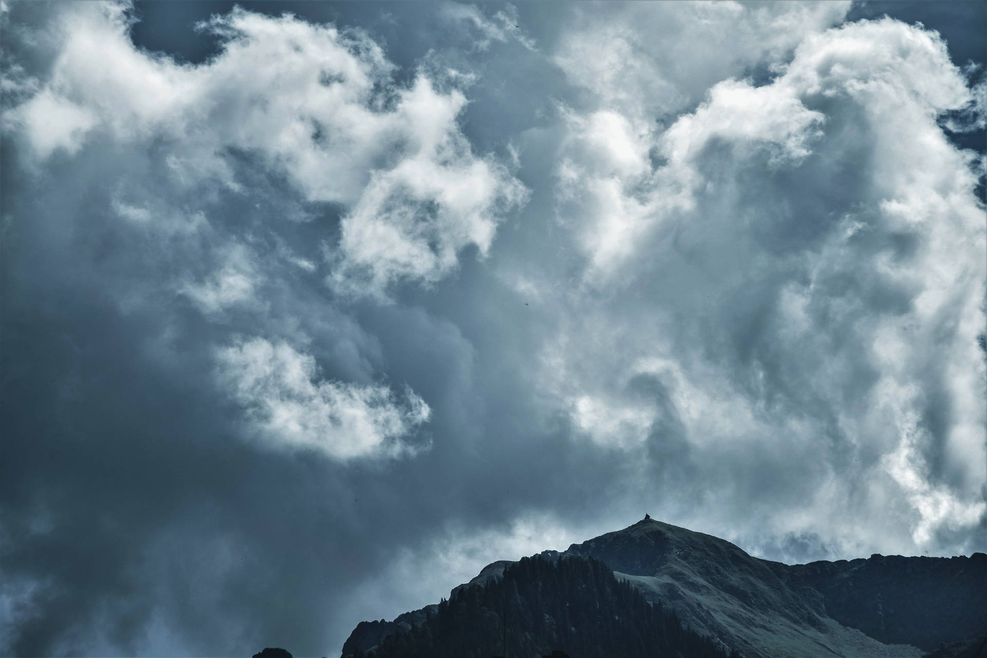 Towering Cumulonimbus Clouds Over Mountain Background