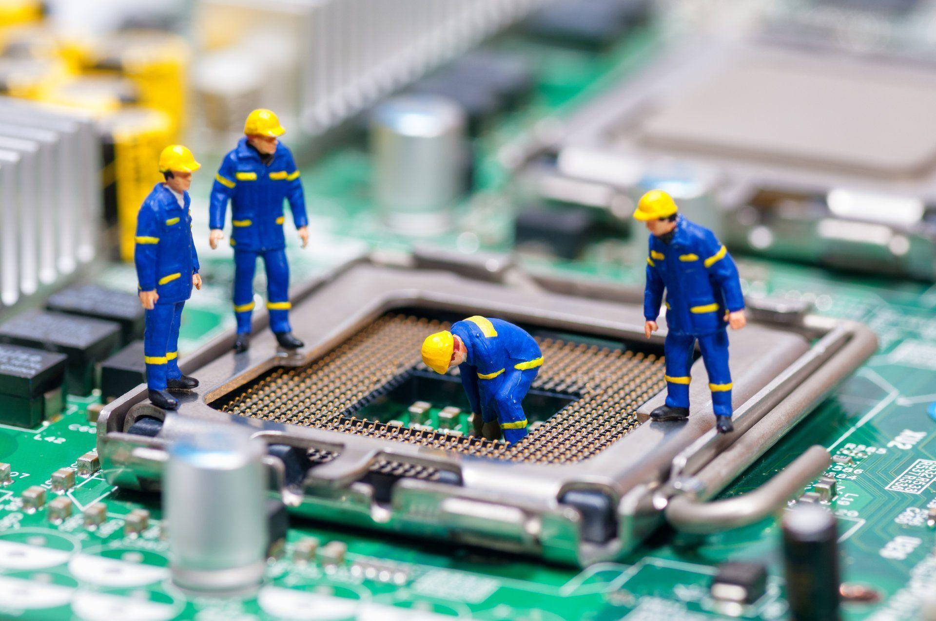 Toy Workers In Motherboard Background