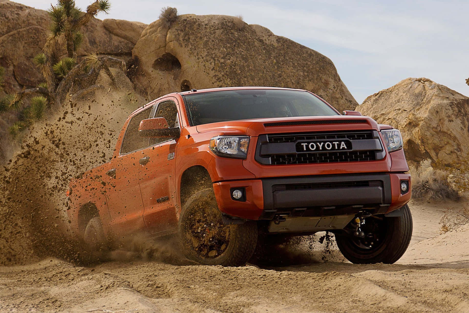 Toyota Trd Driving Through Rough Terrain Background
