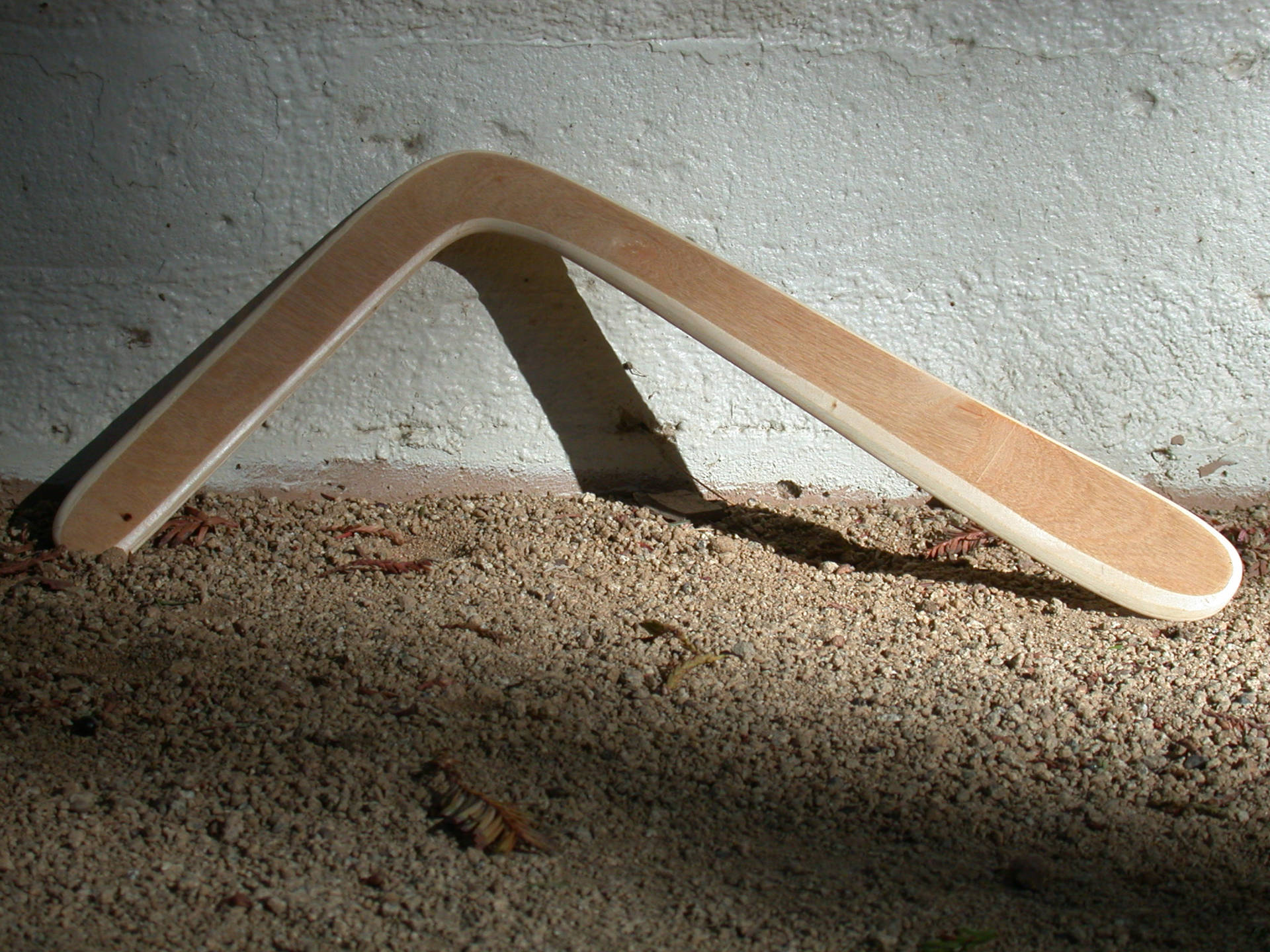 Traditional Boomerang Grounded Against A Sunrise Background