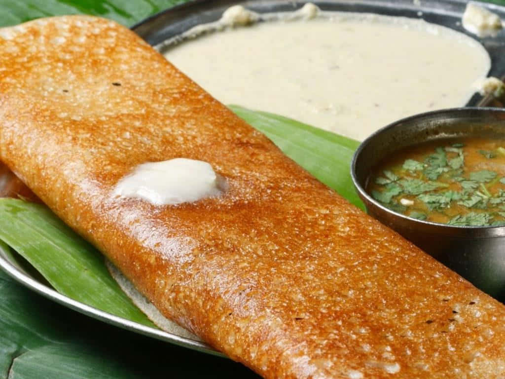 Traditional Indian Dosawith Chutneyand Sambar Background