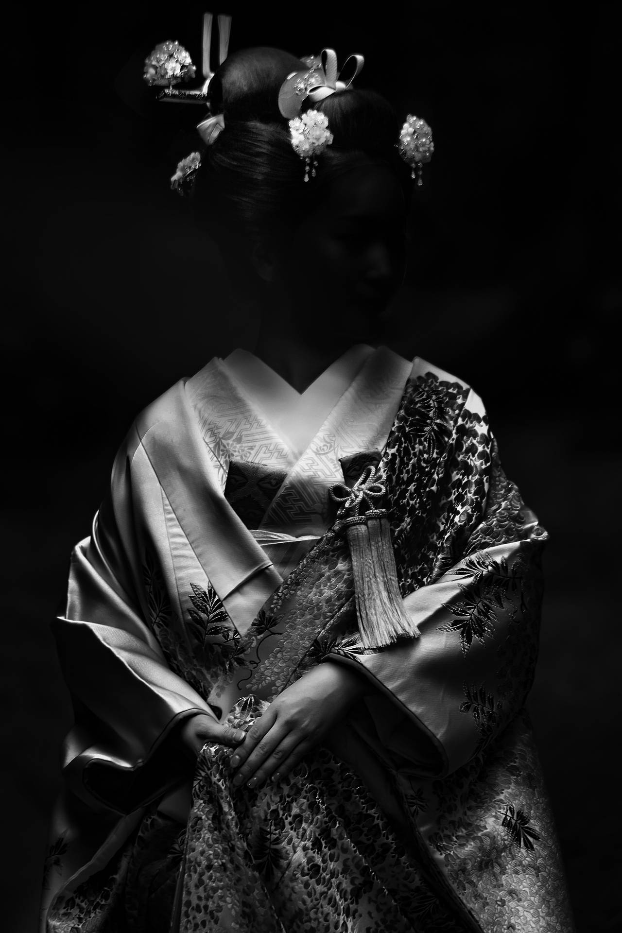 Traditional Japanese Geisha In A Dark Setting Background