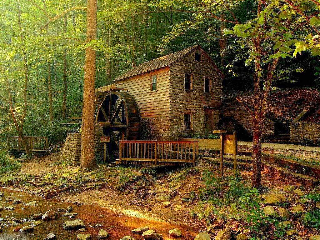 Traditional Mill House Nestled In The Forest Background