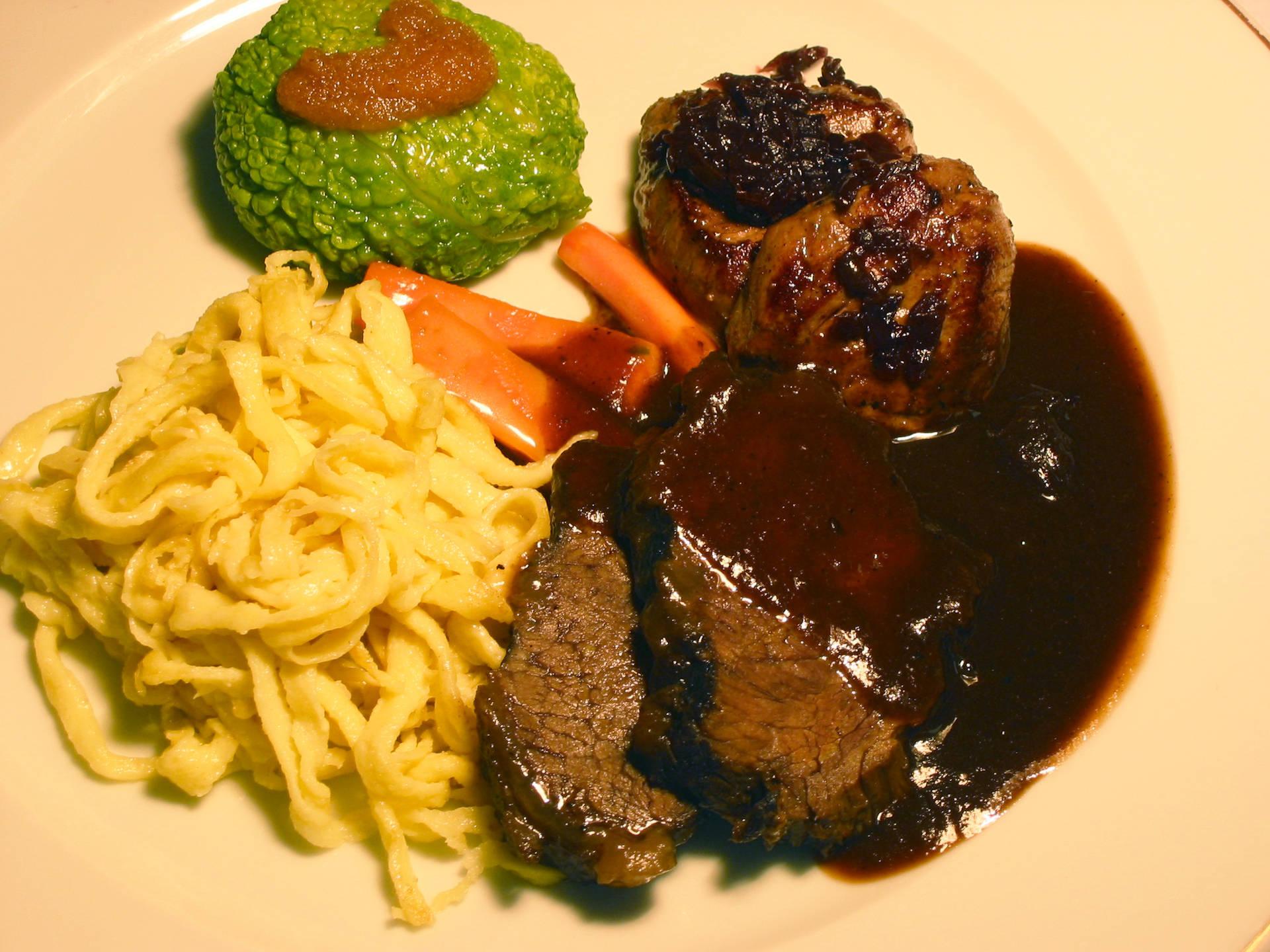 Traditional Sauerbraten Dish Served With Pasta And Mashed Vegetables