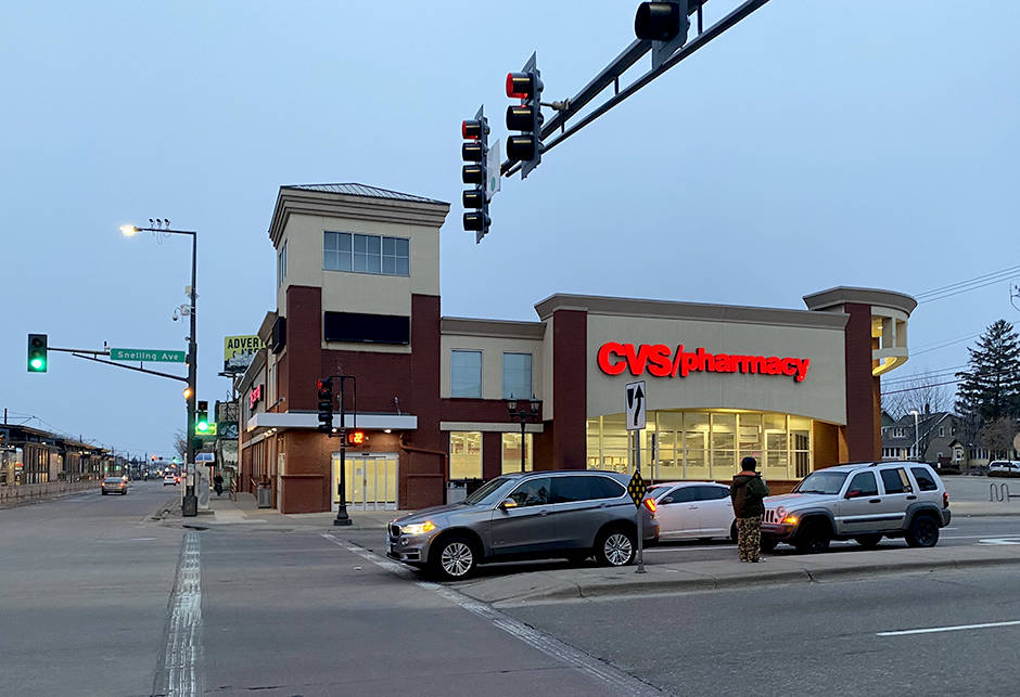 Traffic In Front Of A Cvs Pharmacy Background