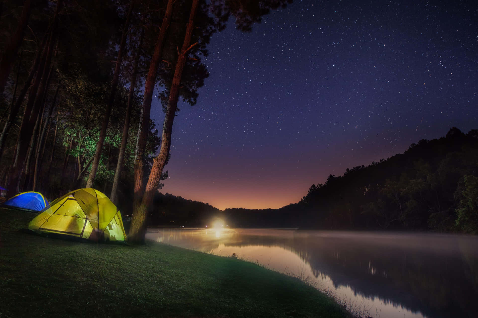 Tranquil Camping Beside A Lake Background