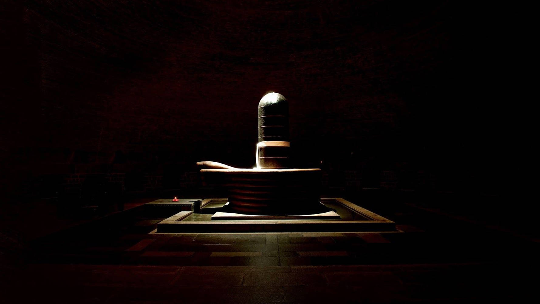Tranquil Display Of Shiva Lingam Stone Background